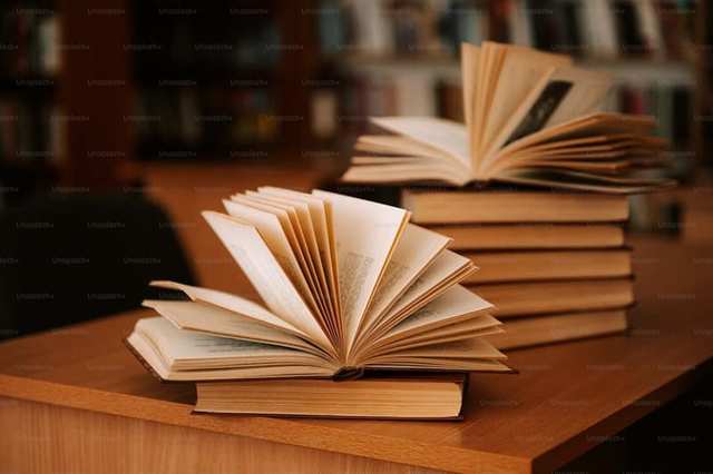Open books arranged on a desk