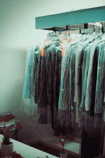 Clothes hanging in dry-cleaning bags