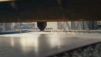 Laser engraving machine cutting a metal sheet