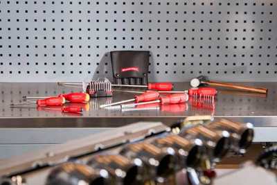 Red-handled hand tools arranged on a workbench