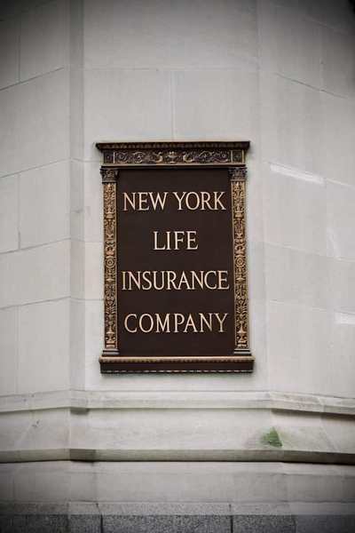 Historic insurance company sign mounted on a stone building