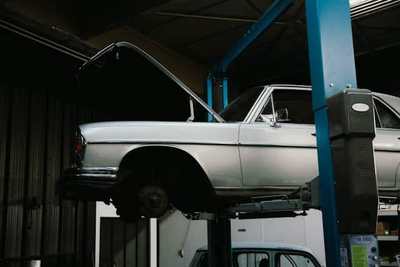 Classic car raised on a workshop service lift